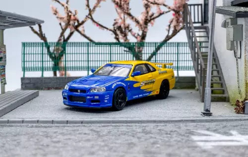 Diecast sports model car with blue body and yellow accents, front 3/4 view