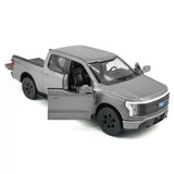 Gray diecast toy pickup truck with open doors, pull-back model car