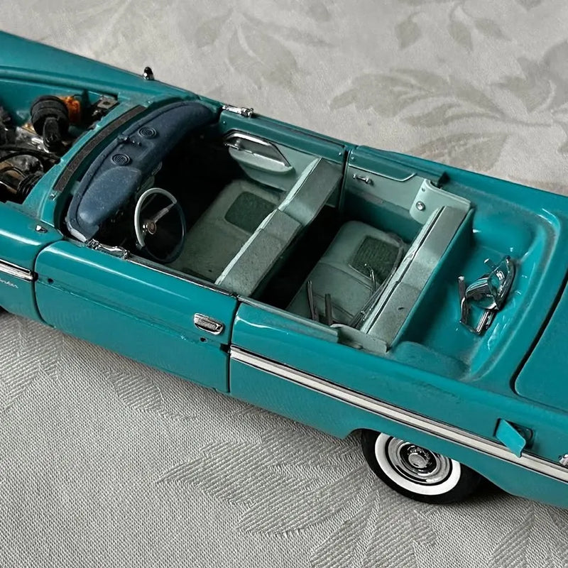 Danbury Mint diecast convertible model car in teal with open cabin and interior seats