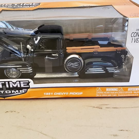 1/24 diecast 1951 Chevy pickup truck, black with chrome details and gold trim.