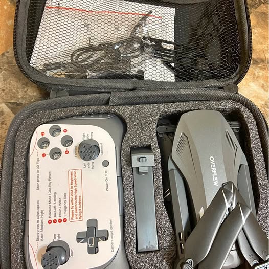 Drone with audio in zip case, showing remote controller and components
