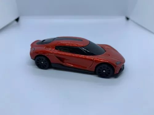 Red diecast car model, 1:64 scale Koenigsegg Gemera, front three-quarter view