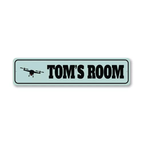 Rectangular metal room sign with drone silhouette and text 'TOM'S ROOM'