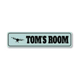 Rectangular metal room sign with drone silhouette and text 'TOM'S ROOM'