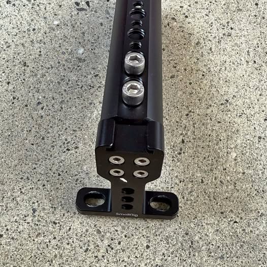 SmallRig screw-on camera handle base with mounting holes and two thumbscrews