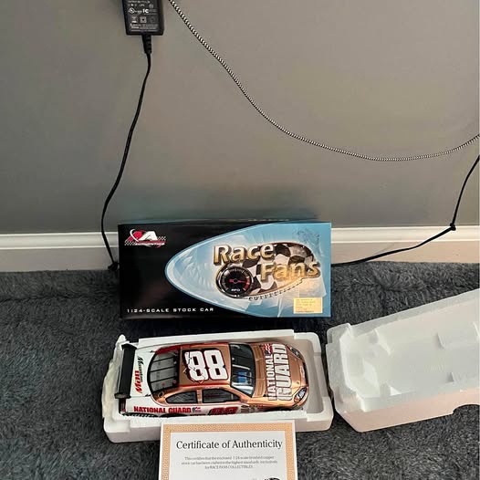 1:24 diecast race car with hood number 88 in open packaging, includes certificate