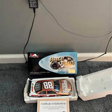 1:24 diecast race car with hood number 88 in open packaging, includes certificate