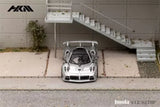 Silver 1:64 diecast model car with front lights and grille detail, front view.
