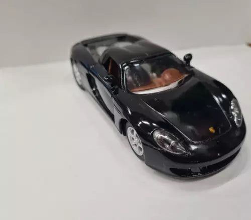 Black Porsche Carrera GT diecast toy car, 1:36 scale, front view