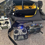 DJI goggles and drone controller set in open black carry case with yellow lining