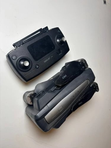 Black 4K camera drone with remote controller, screens and joysticks visible