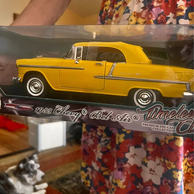 Yellow 1955 Chevrolet Bel Air die-cast convertible car with black soft top