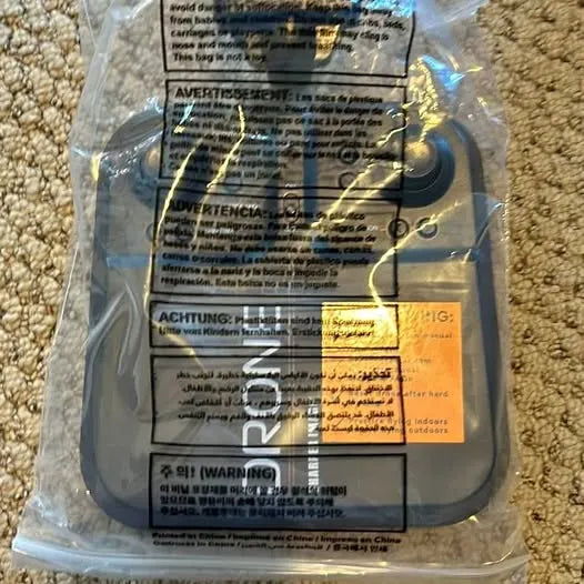 Drone part in clear plastic packaging with warning and instruction labels