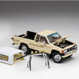 Beige diecast pickup truck model with open hood and black grille, 4x4 stance