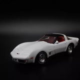 1:64 die-cast sports car model, white with red interior and black wheels