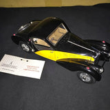 Black and yellow diecast model car with silver trim and detailed wheels