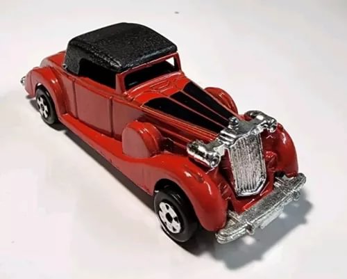 Red diecast model car with black convertible top, chrome grille and bumpers
