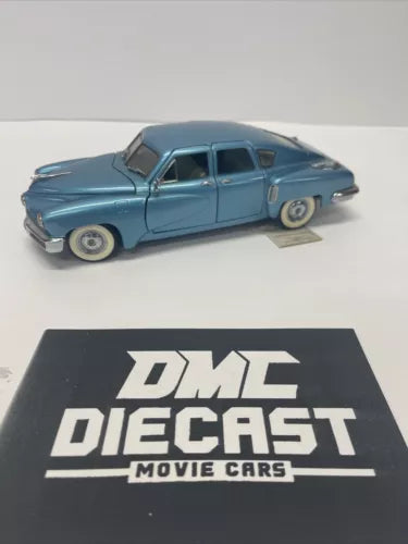 Blue diecast 1948 four-door Tucker Torpedo sedan model in 1/24 scale