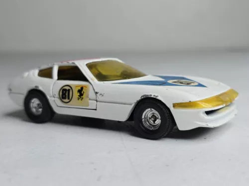 1:36 diecast toy car, white with blue stripe and yellow-tinted windshield, front 3/4 view
