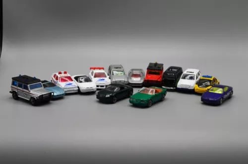 Loose diecast car lot with multiple small sports and sedan models, assorted colors