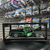 GMC Sierra pickup diecast model in display box, green with black details
