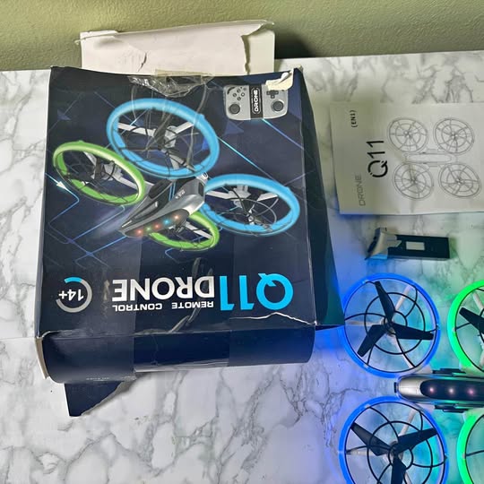 Drone retail box with blue and green quadcopter graphic, glossy packaging