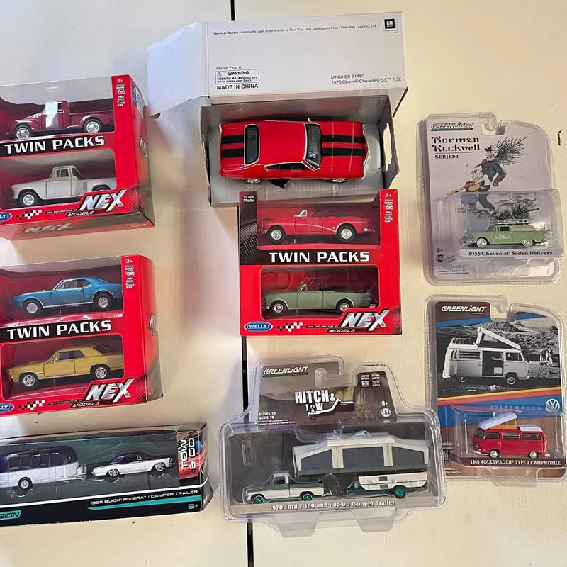 Diecast car and truck set in twin-pack boxes with red, green, and camper vehicles