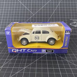 Cream VW Beetle diecast toy car in retail box with QHT Car logo and Racing text