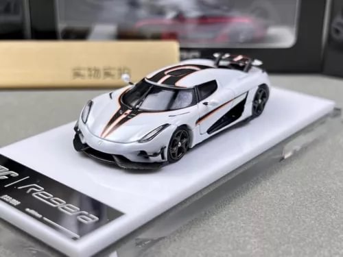 White diecast sports model car with black accents, detailed racing styling on display base