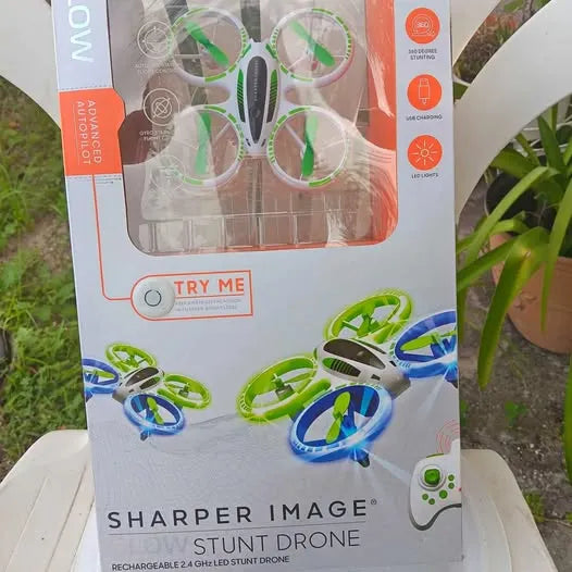 Stunt drone in retail box with green and blue propeller frames