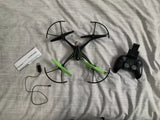 Compact green and black streaming drone with remote controller and connecting cables