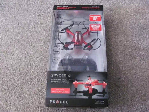 Red RC quadcopter drone in retail packaging box