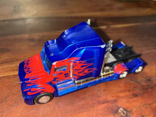 Blue diecast semi truck with flame decals, loose parts