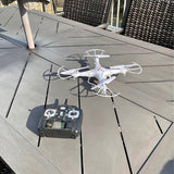 White quadcopter drone with gray remote controller