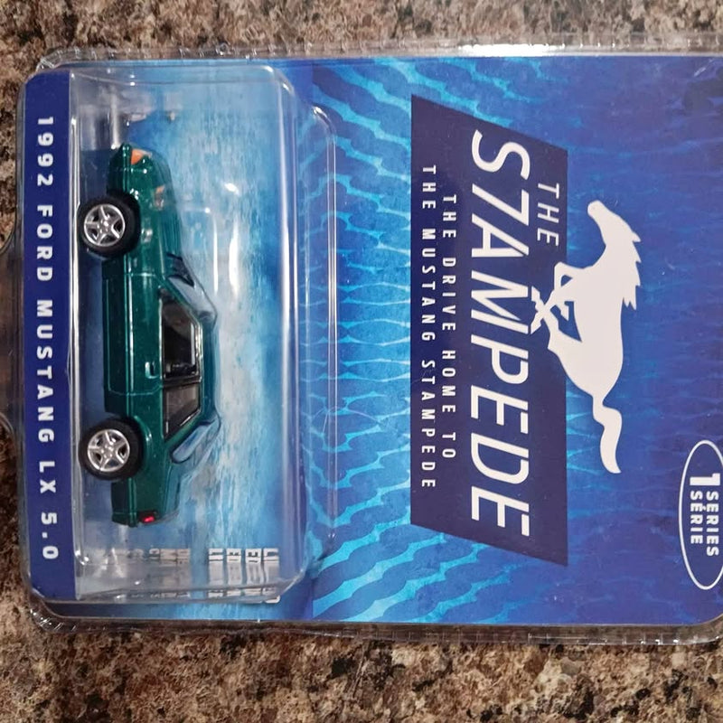 Green 1992-style Mustang diecast car in clear blister package