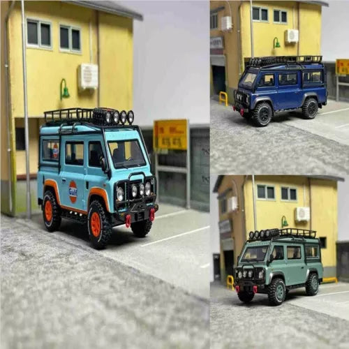 1:64 diecast Land Rover Defender SUV model, blue and orange with roof lights