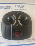 Black drone remote controller with two thumb joysticks and a red emblem button