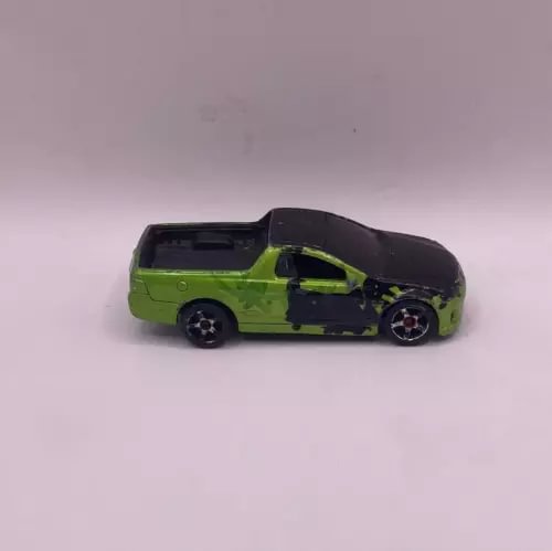 Green and black diecast pickup truck model with detailed wheels