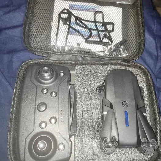Drone travel case with controller and folded drone body in compartments