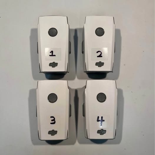 Dji Mavic Air 2 battery packs, four white units with charge indicator