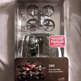Palm-sized performance drone (X09) in box, with quad propellers