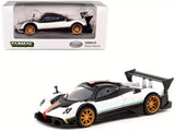 Diecast race car model in white and black, with gold wheels and rear wing