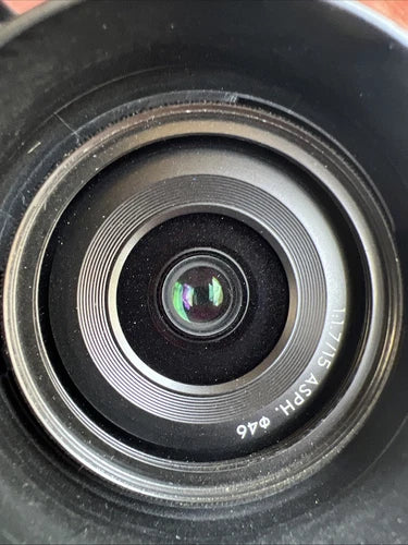 Camera lens with silver ring and glass center, engraved markings
