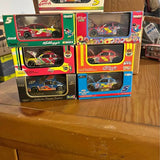 1/64 scale NASCAR diecast cars in colorful boxed packaging, red and blue race cars