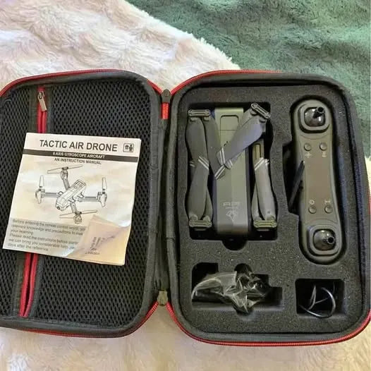Air drone kit in open hard case with folded drone and spare parts compartments