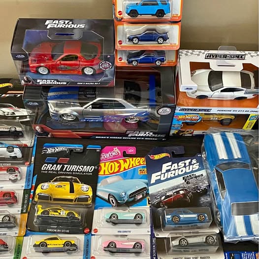 Diecast car assortment with multiple Hot Wheels vehicles in retail boxes