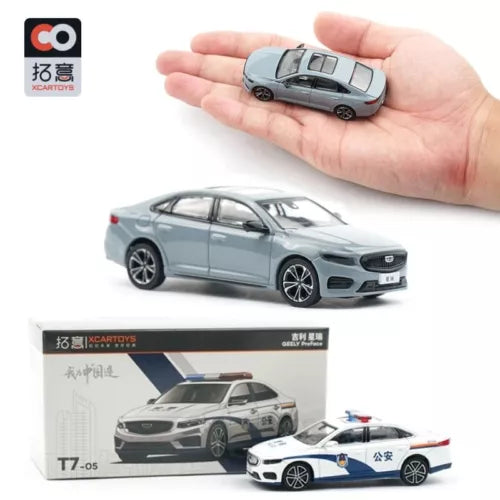 Sky gray diecast sedan model held in hand, with second police car in box