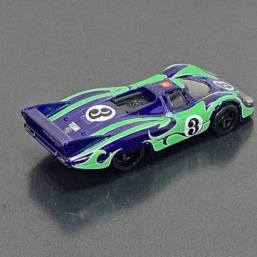 Hot Wheels Porsche diecast car, purple with green graphics and number 3