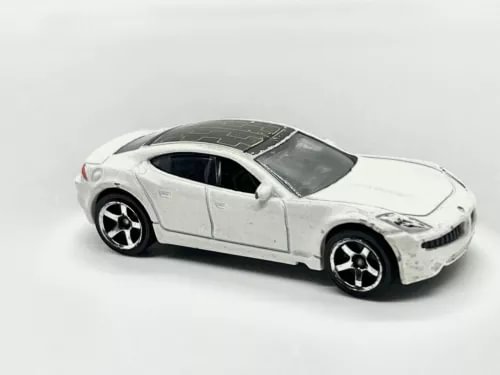 White 1/64 diecast sports car model with black wheels and tinted windows