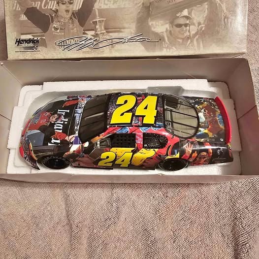 Diecast race car model with bold yellow number 24 on black and red body